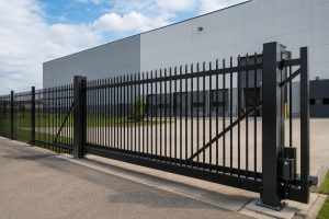 Metal industrial fence installed around a commercial warehouse for maximum security.